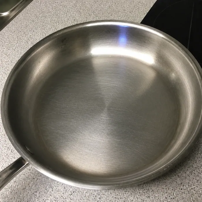 The same pan scrubbed back to bare stainless steel