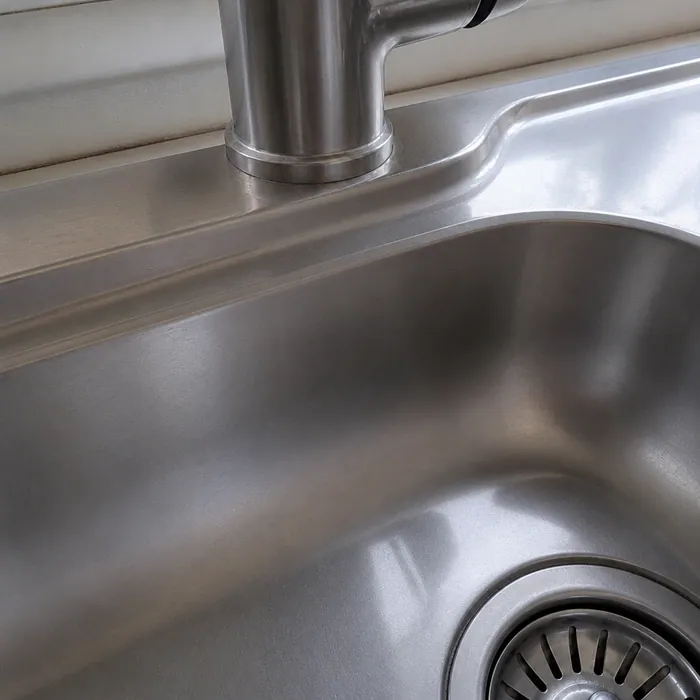 The same sink and tap base cleaned and bright